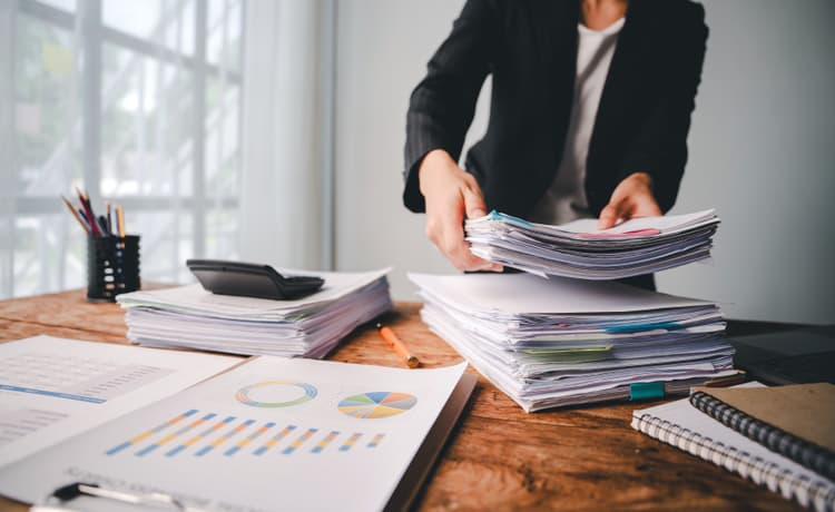 Regulamin organizacyjny przedszkola. Czy schemat organizacyjny przedszkola jest obowiązkowy. Na zdjęciu: stos dokumentów na biurku.